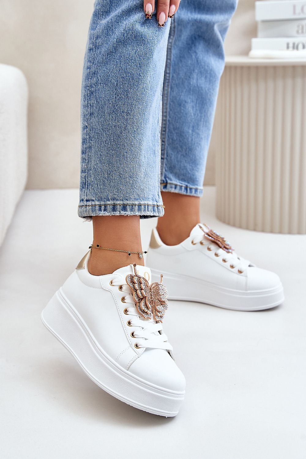 White sneakers with decorative shiny butterfly