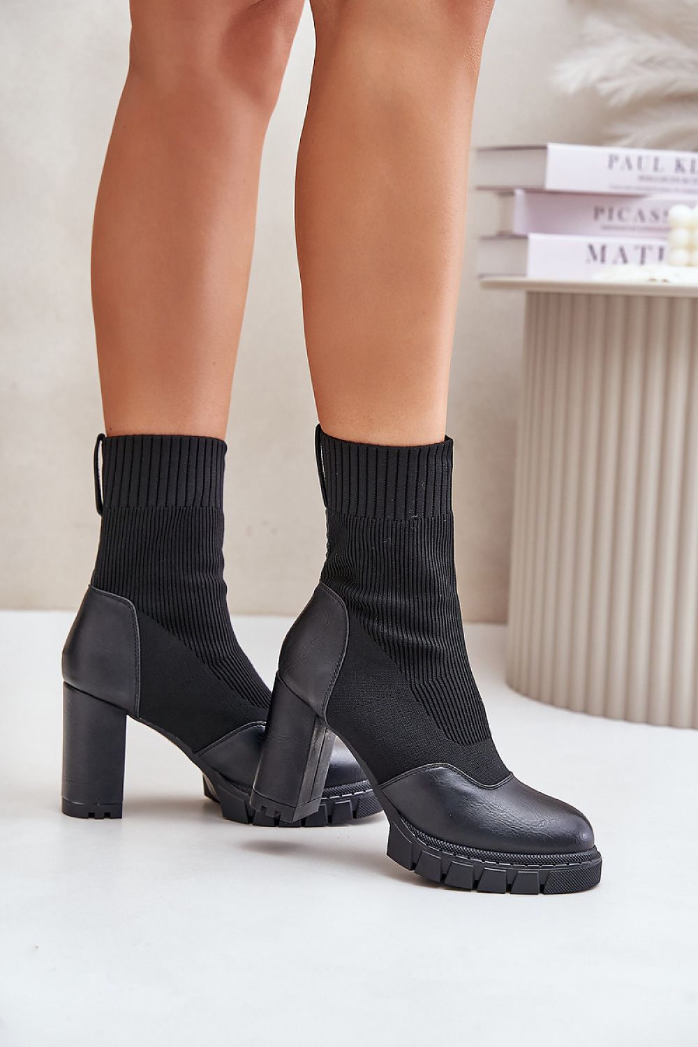 Black ankle boots with a sock-like upper