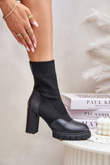 Black ankle boots with a sock-like upper