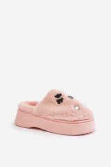 Women's pink fur slippers on a thick platform