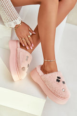 Women's pink fur slippers on a thick platform