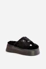 Women's black fur slippers on a thick sole