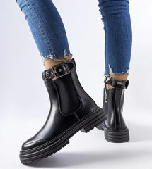 Black ankle boots with decorative fastening