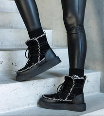 Black snow boots on a lace-up platform