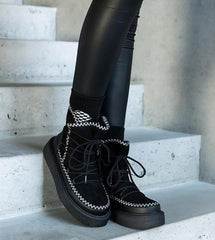 Black snow boots on a lace-up platform