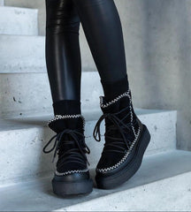 Black snow boots on a lace-up platform