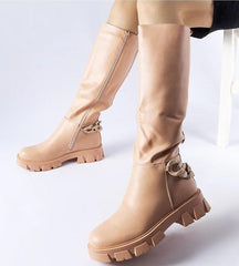 Pink flat knee-high boots with a chain