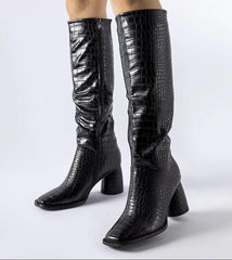 Elegant black boots decorated with embossing