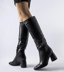 Elegant black boots decorated with embossing