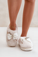 Charming buttons and a bow furry slipper