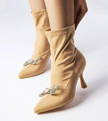 Elegant green heel boots adorned with a zirconia