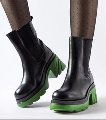 Black insulated boots with a green post