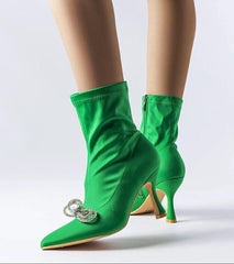 Elegant green heel boots adorned with a zirconia