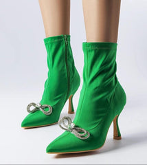 Elegant green heel boots adorned with a zirconia