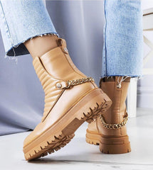 Beige insulated boots with a chain